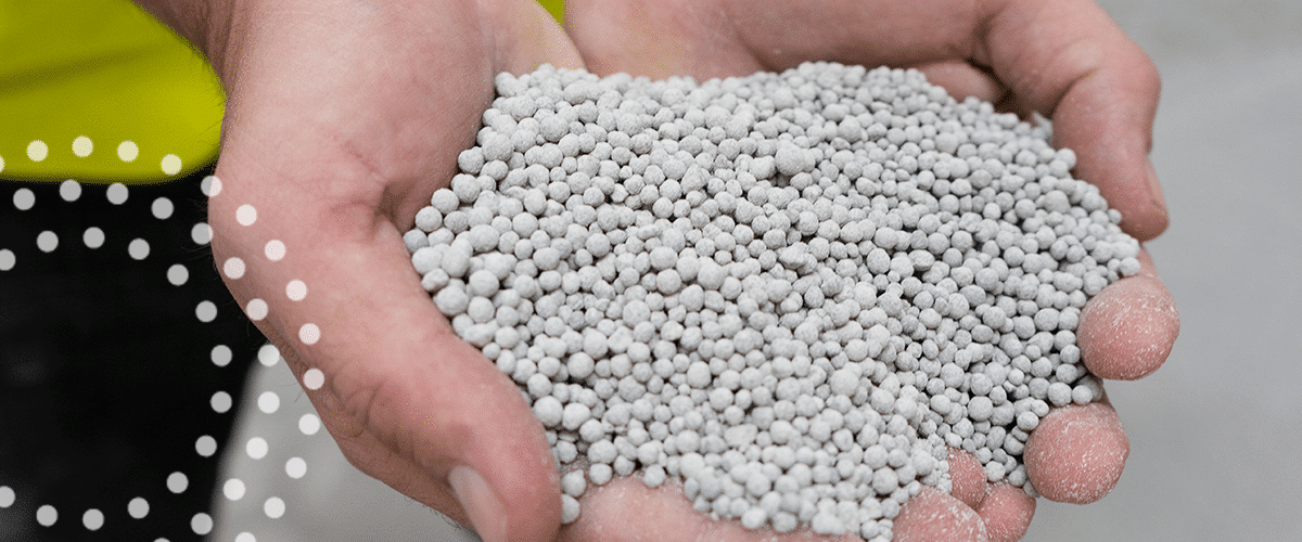 TIMAC AGRO industrial employee holding nitrogen fertilizers.