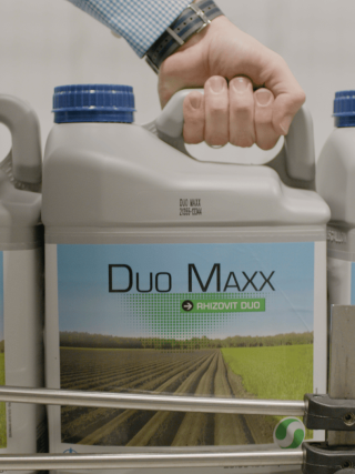 Hand holding DUO MAXX jug.
