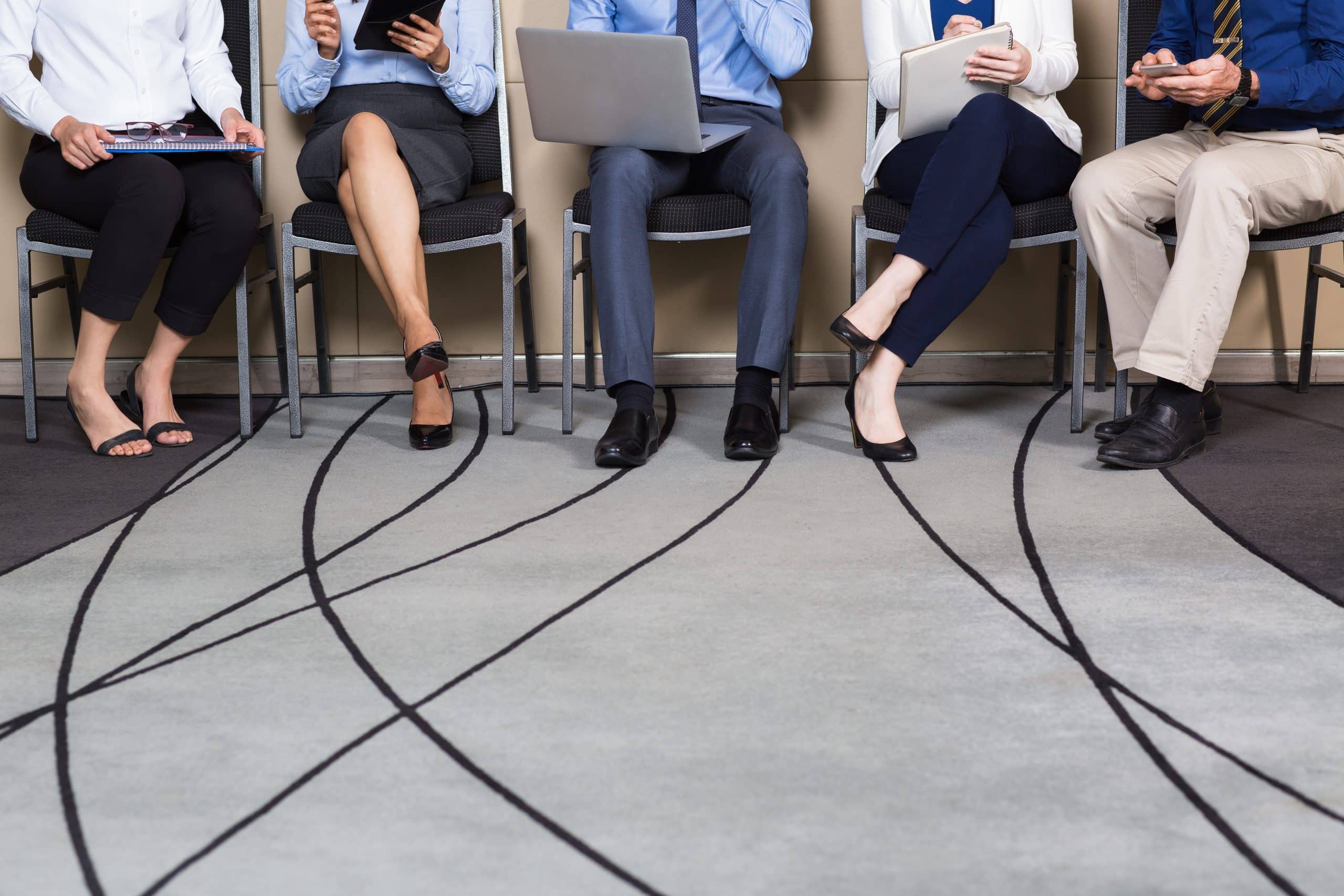 cropped view of business people sitting in row